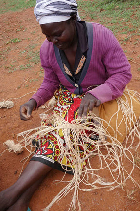 Artist weaving a sisal basket outdoors