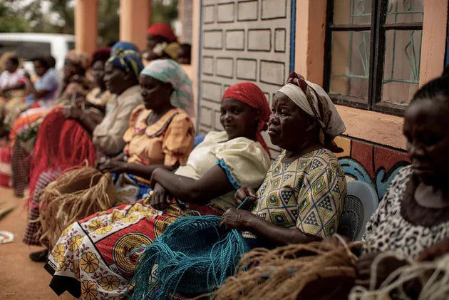 Women working together on woven products
