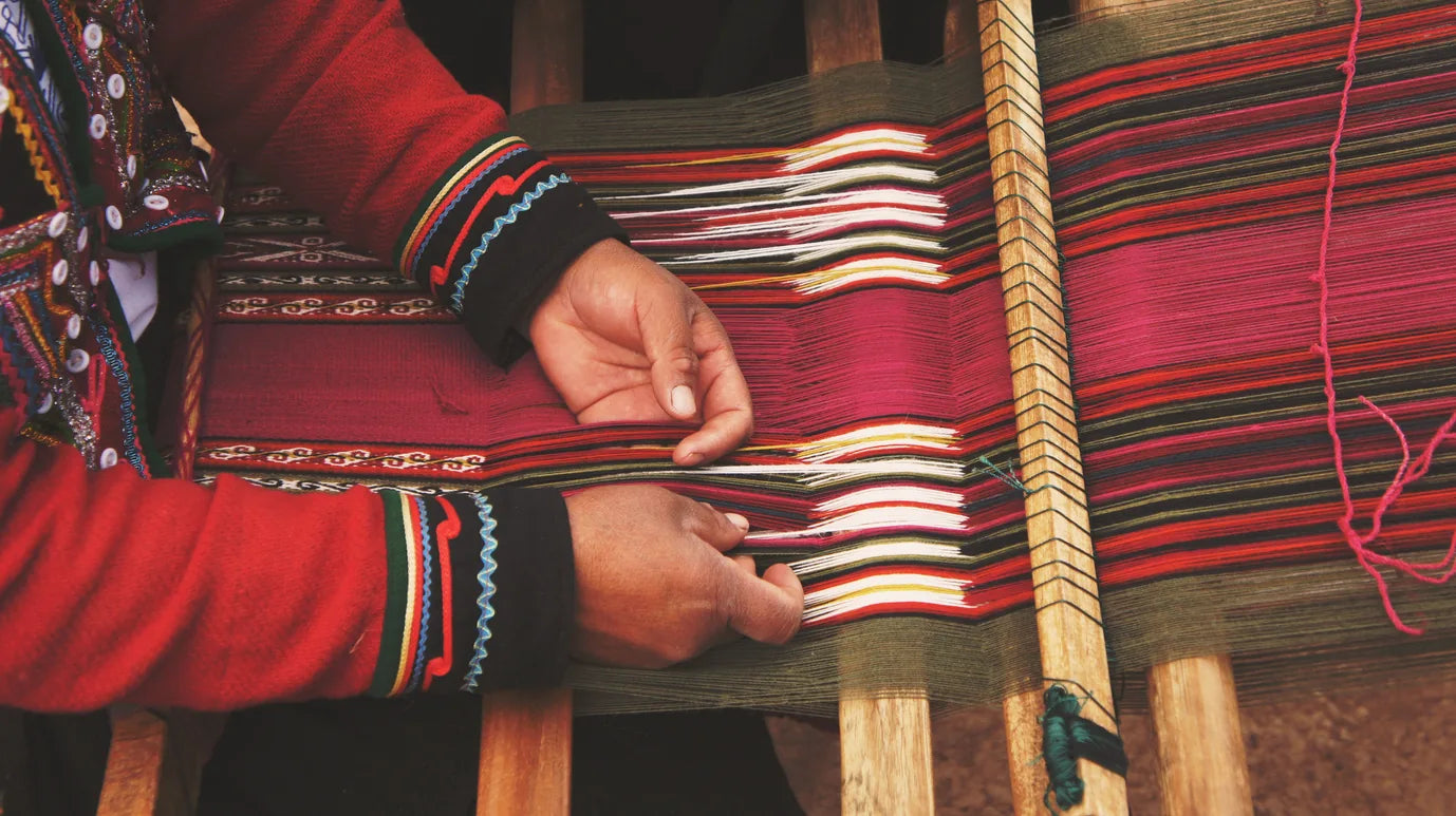 Hands weaving striped textile