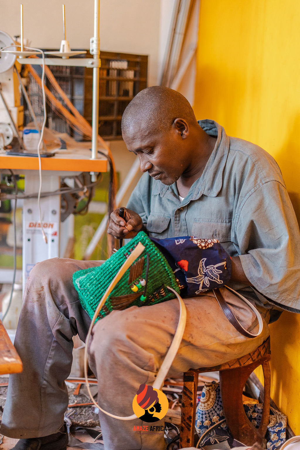 Amaze Africa maker finishing a woven and leather handbag in the workshop
